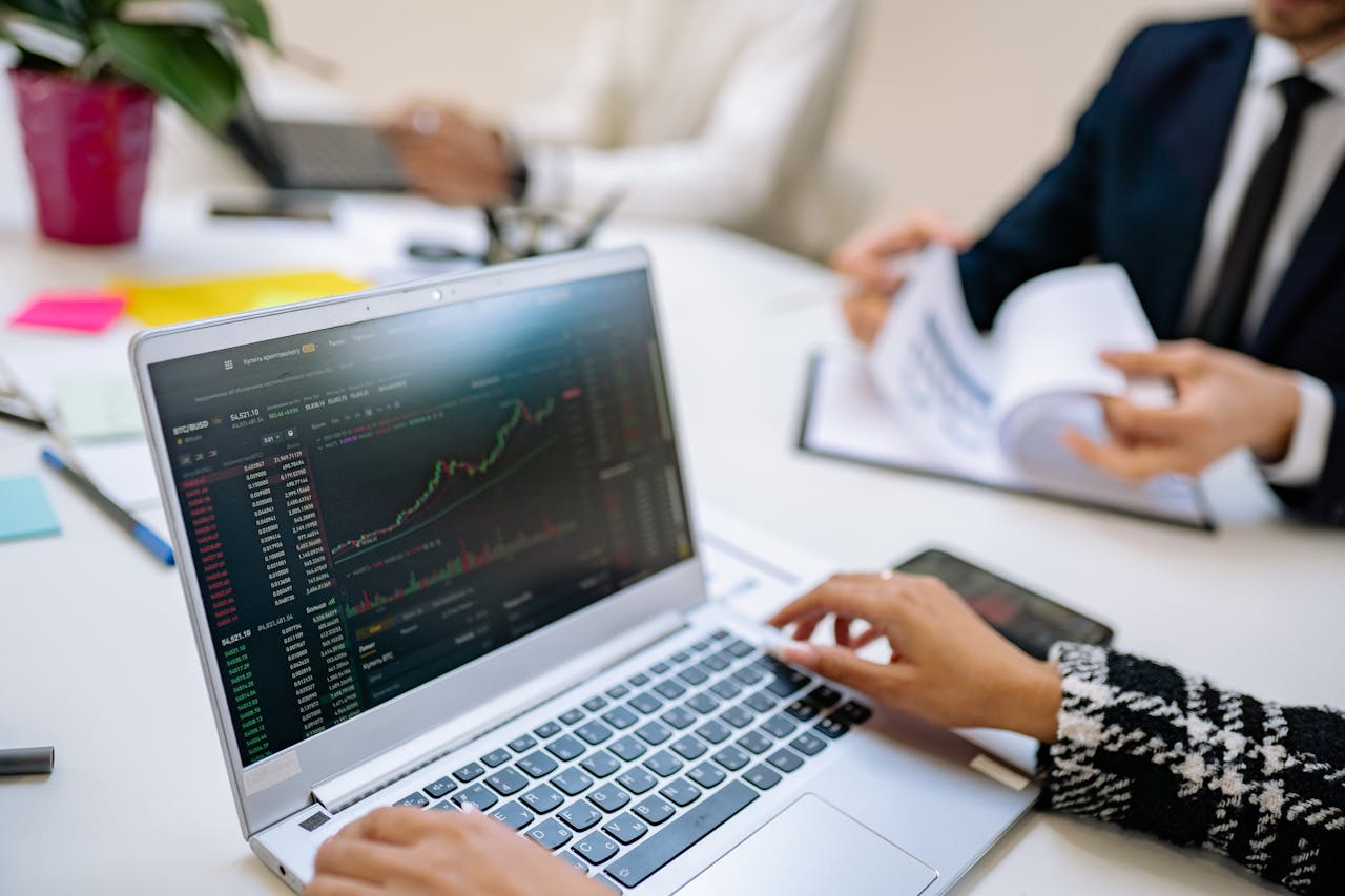 services-img Business team analyzes cryptocurrency market trends using a laptop with graphs and data.